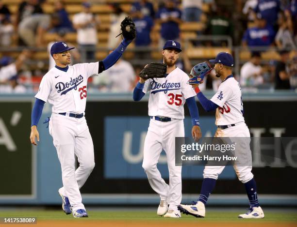 Trayce Thompson, Cody Bellinger and Mookie Betts of the Los Angeles Dodgers celebrate a 10-1 win over the Milwaukee Brewers at Dodger Stadium on...