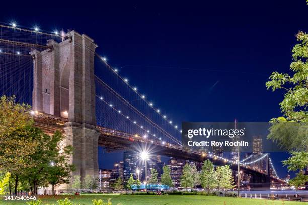 View of the Brooklyn Bridge with the One World Trade Center in the back as part of the downtown Manhattan skyline as seen from Brooklyn Bridge Park...