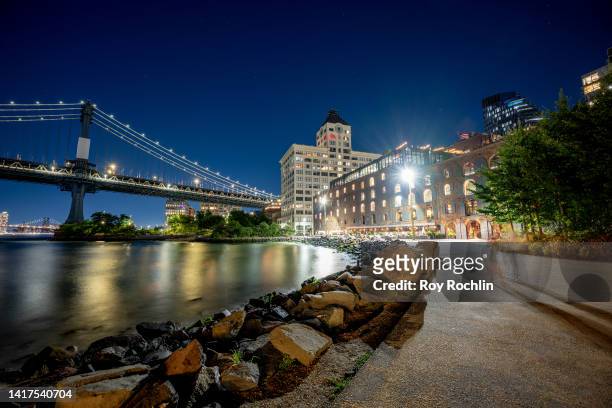 View of the Manhattan Bridge with the Time Out Market on the right as seen from Brooklyn Bridge Park on August 23, 2022 in New York City.