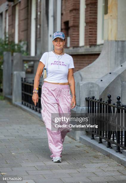 Iris Amber Nijboer wears Cap: ibiza market, white Shirt: BORN IN CHAOS, Necklaces: asos + vintage, pink Pants: diesel, Shoes: mercer amsterdam, Bag:...