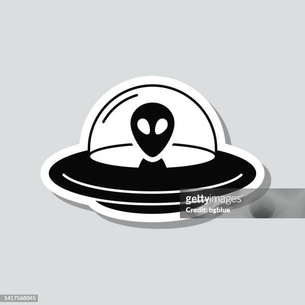 ufo - flying saucer with alien. icon sticker on gray background - grey aliens stock illustrations
