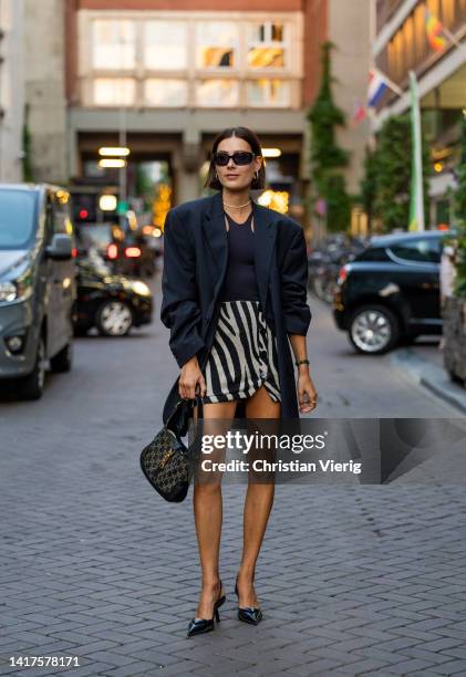 Model Vera van Erp wearing zebra print shorts, navy oversized vintage blazer, Gucci bag, Prada shoes, black top seen outside Vogue Netherlands Event...