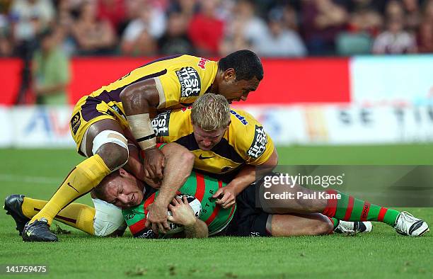 Michael Crocker of the Rabbitohs gets tackled during the round four NRL match between the South Sydney Rabbitohs and the Brisbane Broncos at NIB...