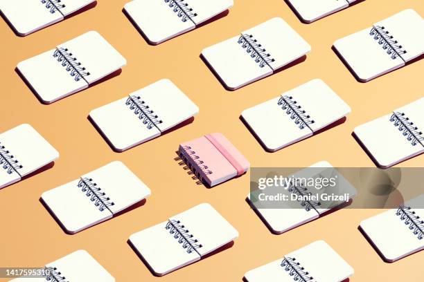 standing out from the crowd - spiral notebook stock pictures, royalty-free photos & images