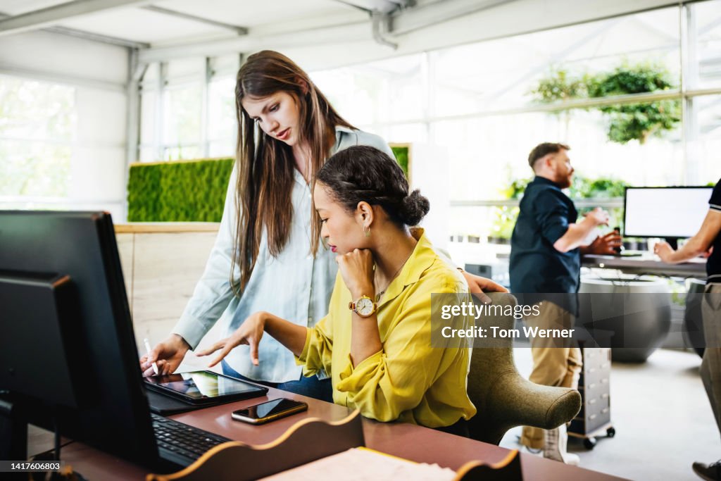 A modern Office Space With Employees Working At Desks