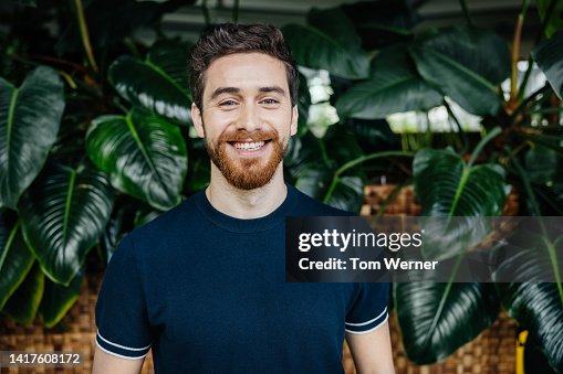 Portrait Of Office Employee Standing In Front Of Lush Foliage Portrait Of Office Employee Standing In Front Of Lush Foliage