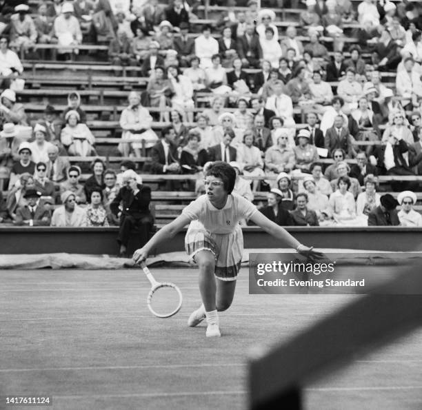 American tennis player Billie Jean Moffitt stoops to make the return during her quarterfinal match of the Women's Singles competition at the 1962...