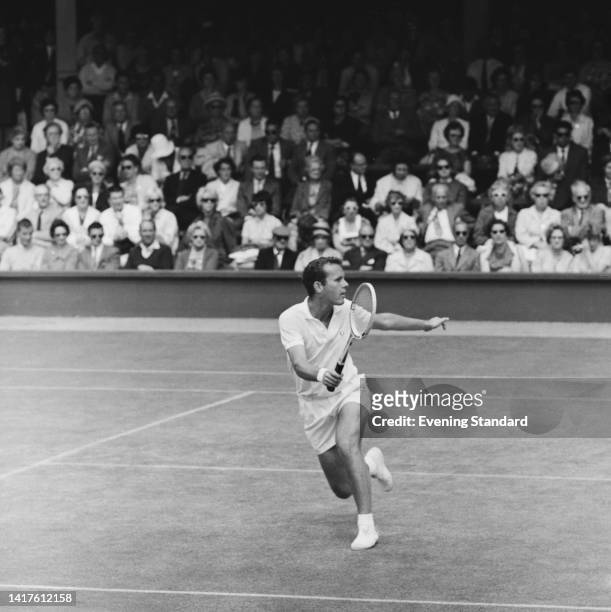 Australian tennis player Ken Fletcher in action during his fourth round match of the Men's Singles competition at the 1962 Wimbledon Championships,...