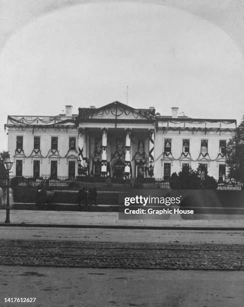 Exterior view of the White House with funerary decorations following the assassination of American politician James A Garfield, in Washington, DC,...