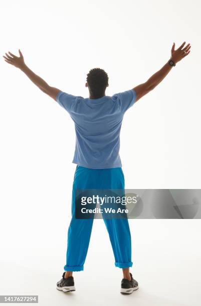 rearview of man with arms outstretched - arms outstretched isolated stock pictures, royalty-free photos & images