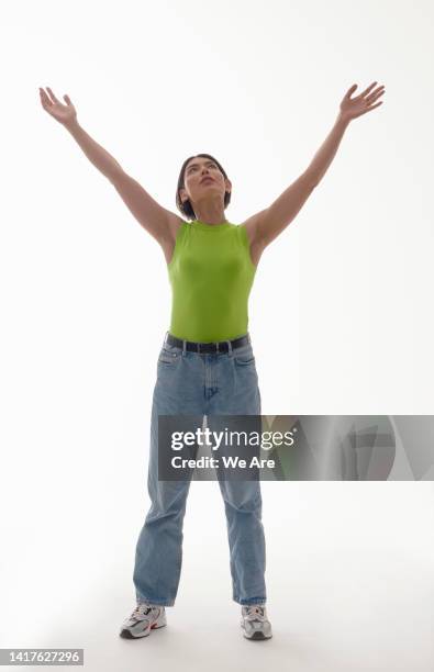 woman with arms outstretched - woman catching stock pictures, royalty-free photos & images