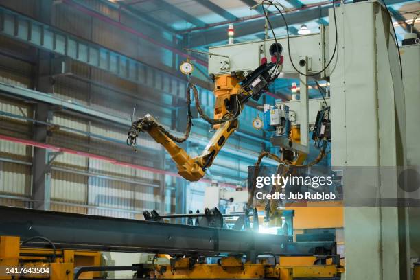 orange color robotic arms manufacturing in industrial factory - artificial arm stock pictures, royalty-free photos & images