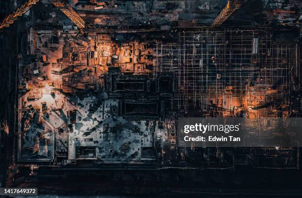under construction site, crane in asian city at night. drone aerial top view. industrial business or civil engineering technology - work sites night stock pictures, royalty-free photos & images