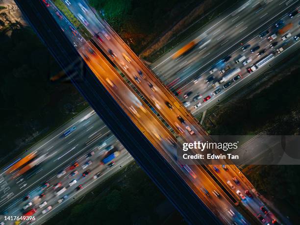 highway heavy traffic at night drone point of view with monorail bridge - trucks on queue stock pictures, royalty-free photos & images