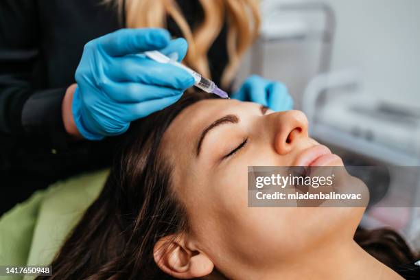 facial aesthetics surgery treatment. - blood plasma stock pictures, royalty-free photos & images