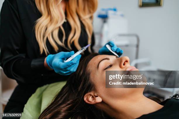 facial aesthetics surgery treatment. - needle injury stock pictures, royalty-free photos & images