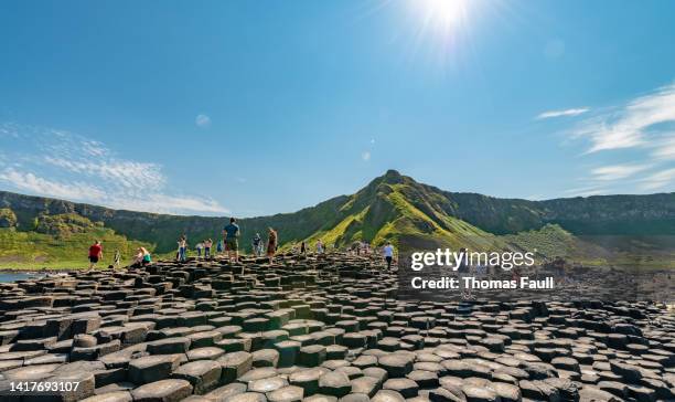 mass tourism at giant's causeway, northern ireland - giants causeway bildbanksfoton och bilder