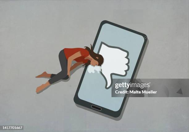 crying woman laying on smart phone with social media dislike button - social media stock illustrations