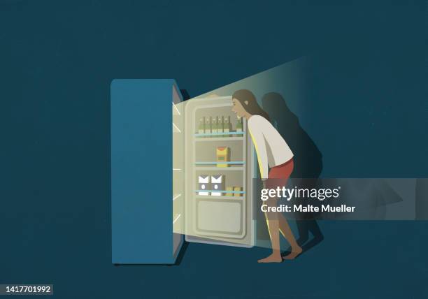 woman standing at open refrigerator in kitchen at night - refrigerator stock illustrations
