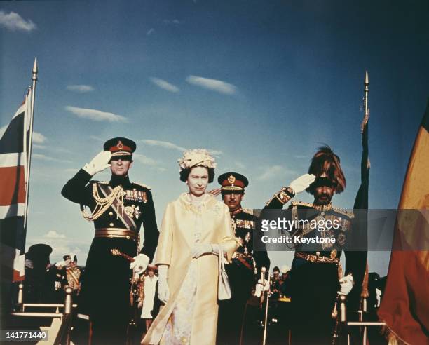 Queen Elizabeth II and Prince Philip with Emperor Haile Selassie I of Ethiopia upon their arrival in Addis Ababa, during a State Visit to Ethiopia,...
