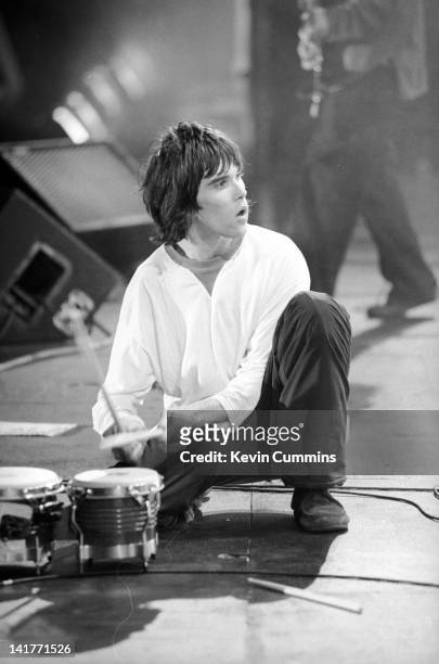 Singer Ian Brown performing with British rock group The Stone Roses at an outdoor concert at Spike Island, Widnes, Cheshire, 27th May 1990.