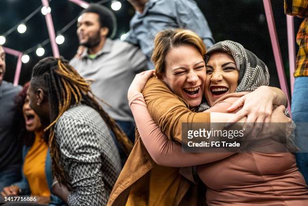 friends watching a sports game and celebrating outdoors - arab group stockfoto's en -beelden