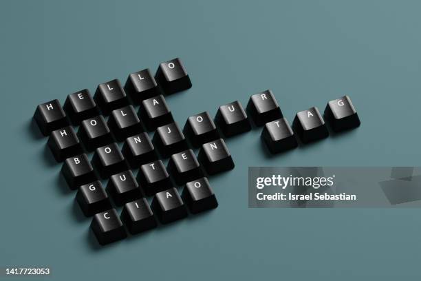 digitally generated image of greeting words written in various languages typed with black keyboard keys on blue background. - key message stock-fotos und bilder