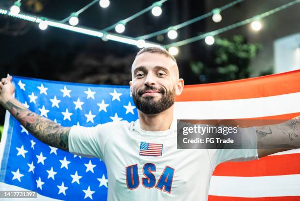 portrait of a mid adult man with a american flag outdoors - fútbol americano stock pictures, royalty-free photos & images
