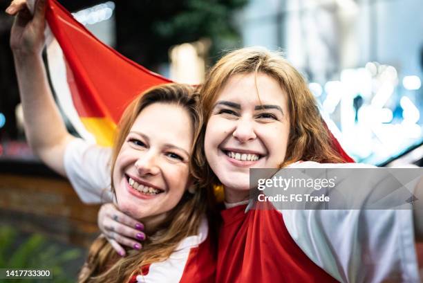 portrait of spanish female friends celebrating outdoors - hispanic day stock pictures, royalty-free photos & images