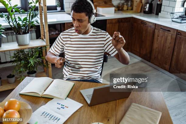 adult student enjoying in music while taking a break from studying - rhythm stock pictures, royalty-free photos & images