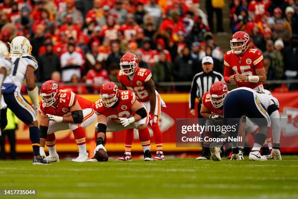 Austin Reiter of the Kansas City Chiefs and offensive guard Laurent Duvernay-Tardif at the line of scrimmage during an NFL football game against the...