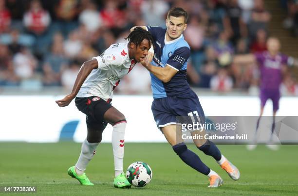 Dylan Kadij of Bristol City is challenged by Anis Mehmeti of Wycombe Wanderers during the Carabao Cup Second Round match between Wycombe Wanderers...