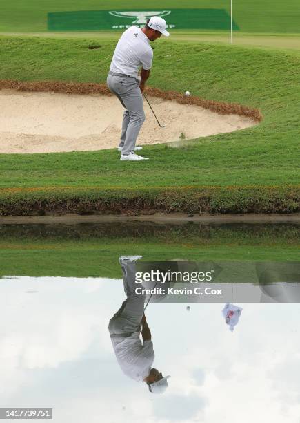 Xander Schauffele of the United States chips on the 15th hole during a practice roundprior to the TOUR Championship at East Lake Golf Club on August...