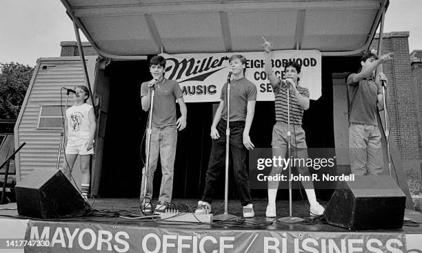 View of members of the American vocal pop group New Kids on the Block perform on stage as part of the 'Miller Lunchtime Concert Series,' Boston,...