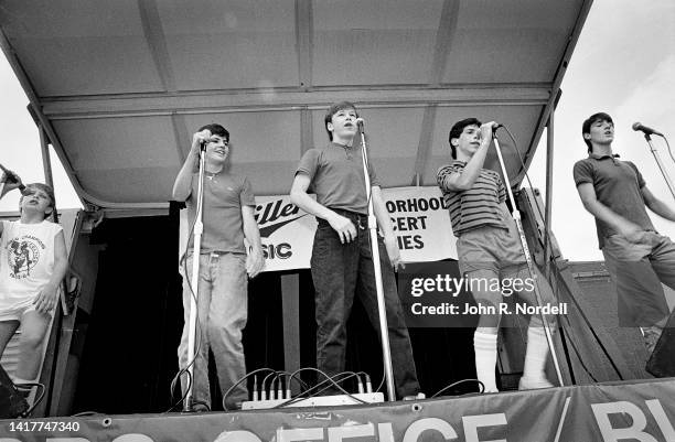 View of members of the American vocal pop group New Kids on the Block perform on stage as part of the 'Miller Lunchtime Concert Series,' Boston,...