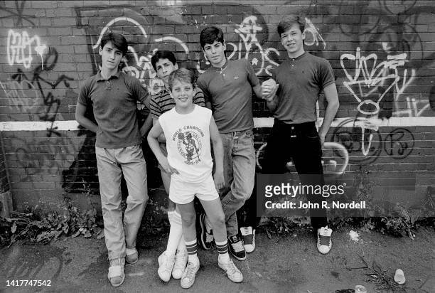 Portrait of the members of American vocal pop group New Kids on the Block as they pose against a graffiti-covered brick wall, Boston, Massachusetts,...