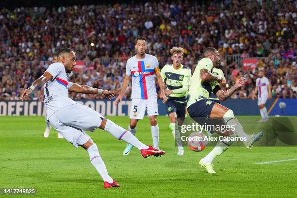 Pierre-Emerick Aubameyang of FC Barcelona scores their team's first goal while under pressure from Kyle Walker of Manchester City during the friendly...