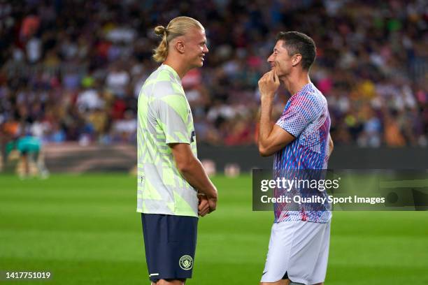 Robert Lewandowski of FC Barcelona talks with Erling Haaland of Manchester City during the friendly match between FC Barcelona and Manchester City at...