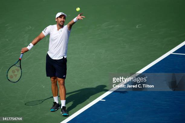 Steve Johnson of United States serves to Richard Gasquet of France during their third round match on day five of the Winston-Salem Open at Wake...