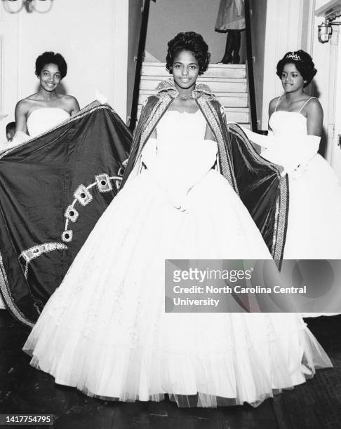 Margaret P. McCullough, left, and Gloria Rankin, right, assist Constance L. Black, "Miss North Carolina College, with her train before coronation...
