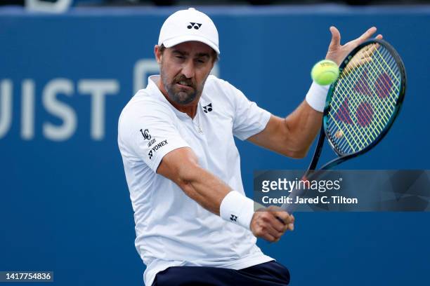 Steve Johnson returns a shot from Richard Gasquet of France during their third round match on day five of the Winston-Salem Open at Wake Forest...