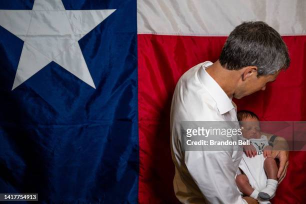 Texas Democratic gubernatorial candidate Beto O'Rourke holds 10-day-year-old Davis Roddy for a picture during a campaign rally on August 24, 2022 in...
