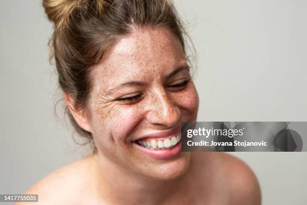 beauty is in everyone.
close-up portrait of a woman with freckles - soft smile stock pictures, royalty-free photos & images