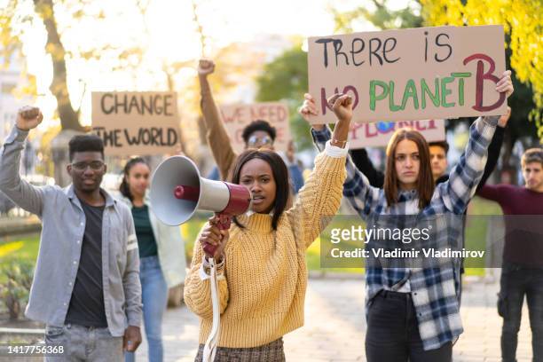 students fighting to save the planet - environmental protest stock pictures, royalty-free photos & images