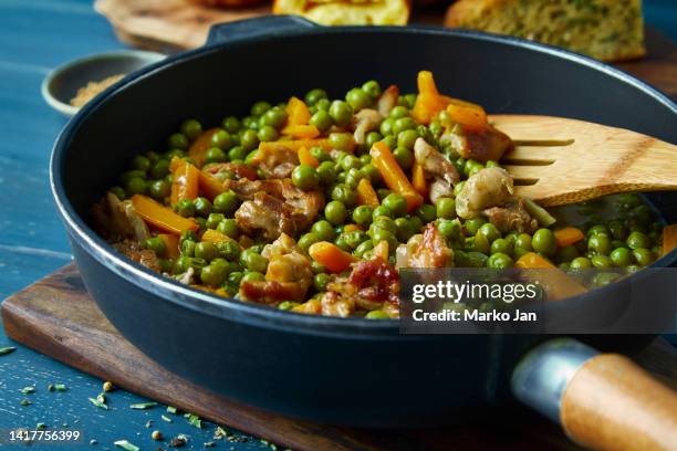 green peas with carrot and chicken meat in a pan - green pea stock pictures, royalty-free photos & images