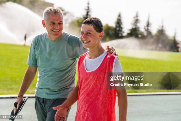 coach talking to the teenage boy athletes - family relay stock pictures, royalty-free photos & images