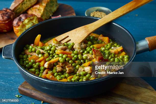 homemade peas with carrot and chicken meat in a pan - chicken stew stock pictures, royalty-free photos & images