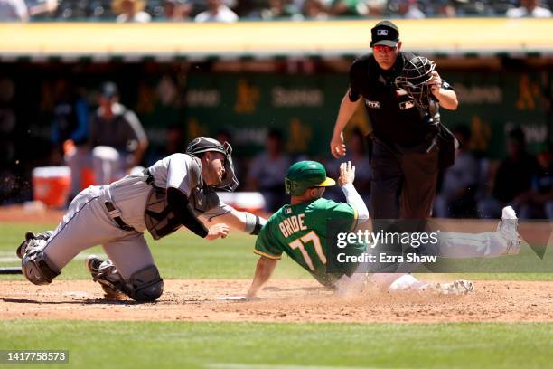 Nick Fortes of the Miami Marlins tags out Jonah Bride of the Oakland Athletics in the sixth inning at RingCentral Coliseum on August 24, 2022 in...