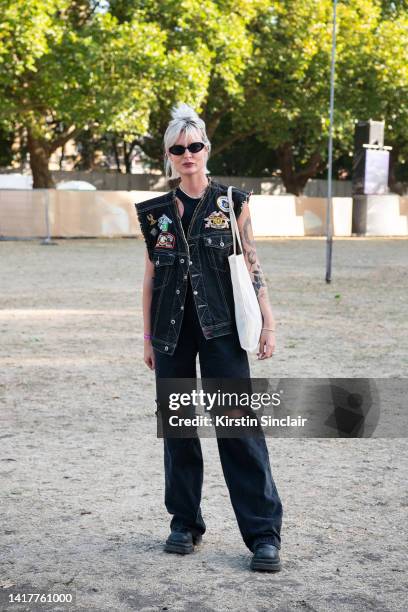 Tash Hall wears Asos boots and top, vintage Harley Davidson sleeveless jacket, vintage jeans and Accessorize sunglasses at Victoria Park on August...