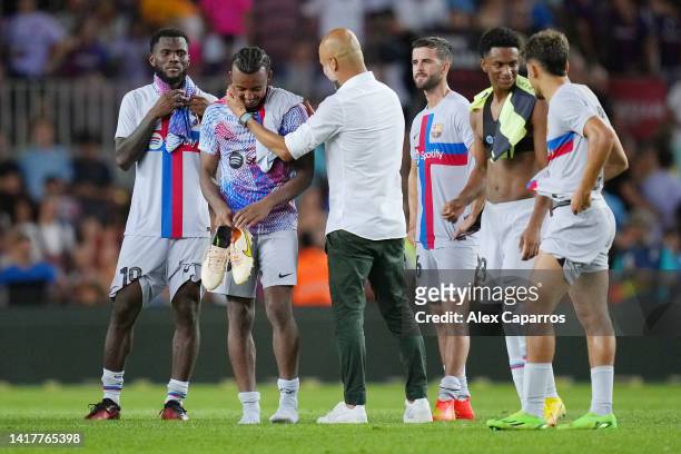 Pep Guardiola, Manager of Manchester City speaks to Jules Kounde of FC Barcelona after the friendly match between FC Barcelona and Manchester City at...